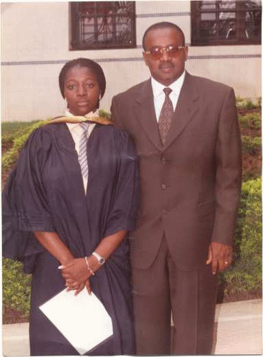 A photograph of a young woman and her father at her graduation ceremony