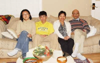 A photograph of a family sitting on a sofa