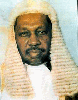 A photograph of a barrister in formal dress and wig