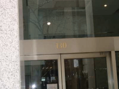 A photograph of the front door of a modern office block